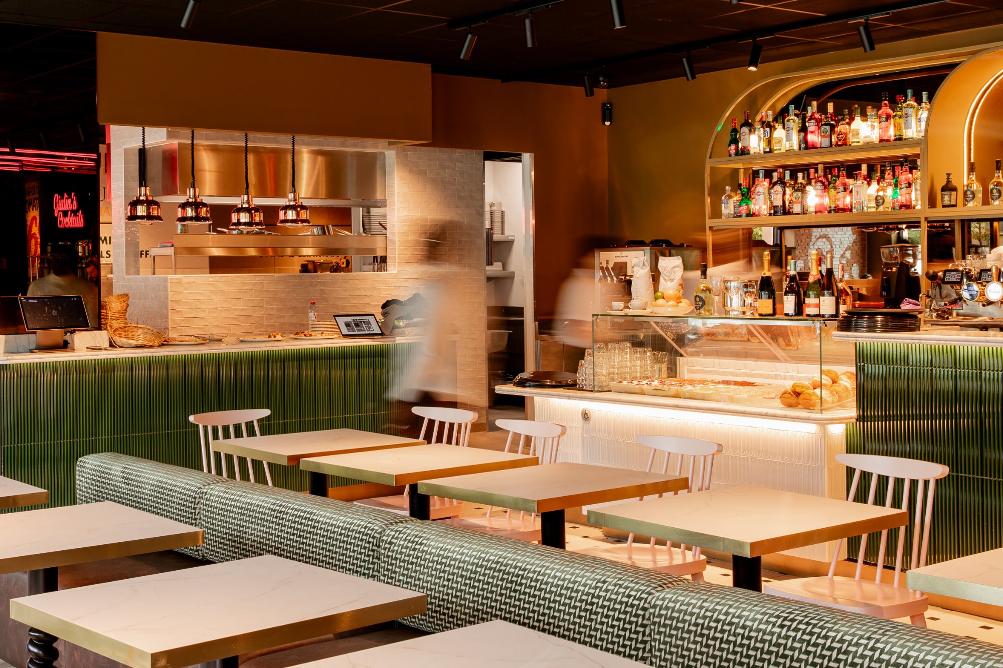 Italian Queen Meylan – dining room with green patterned banquette and arched gold bar, photo Jon Filin