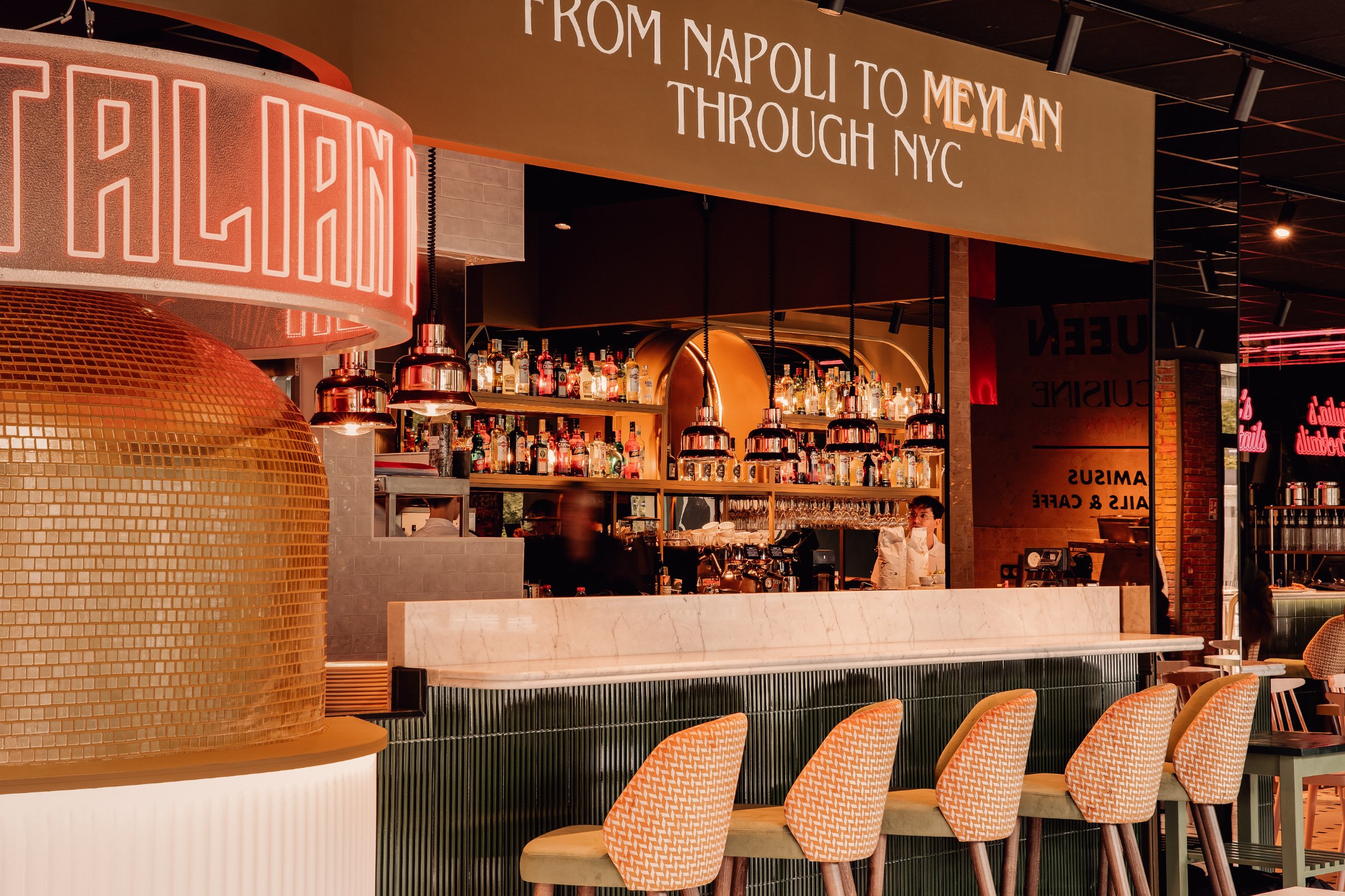 Italian Queen Meylan – neon Italian Queen ring, gold mosaic oven and the From Napoli to Meylan through NYC sign above the bar, photo Jon Filin