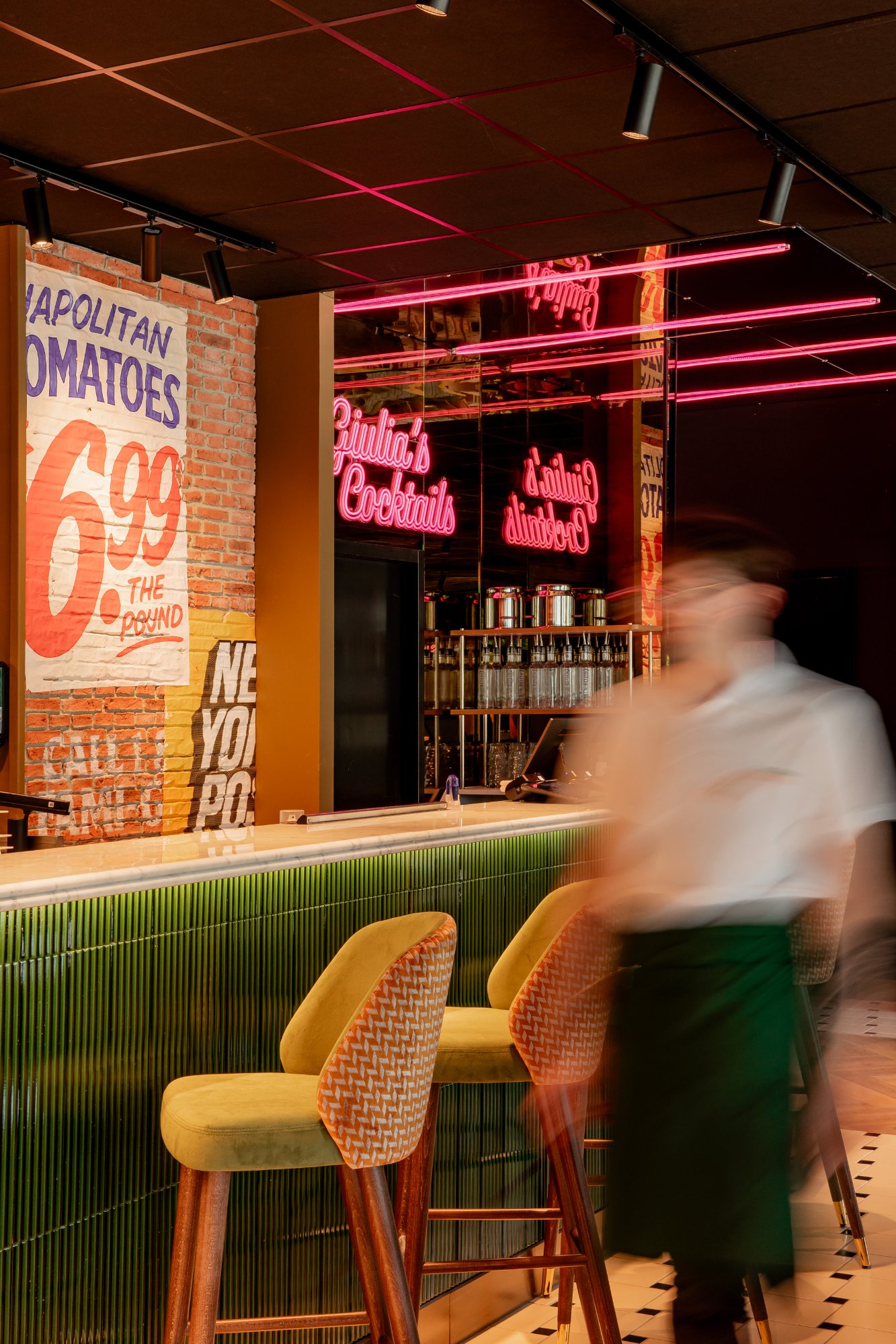 Italian Queen Meylan – Giulia’s Cocktails pink neon and New York poster on brick, photo Jon Filin