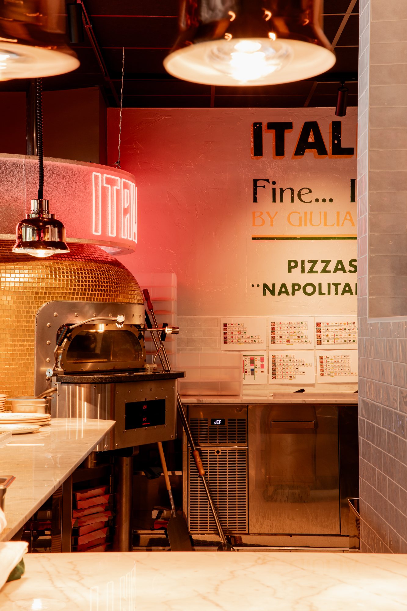 Italian Queen Meylan – hand-painted sign by Giulia above the open kitchen, photo Jon Filin