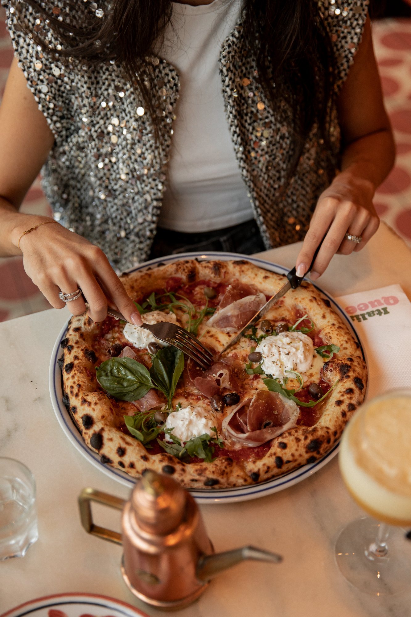 Italian Queen Val d’Europe – Neapolitan pizza with burrata and prosciutto on a marble table, photo Jon Filin